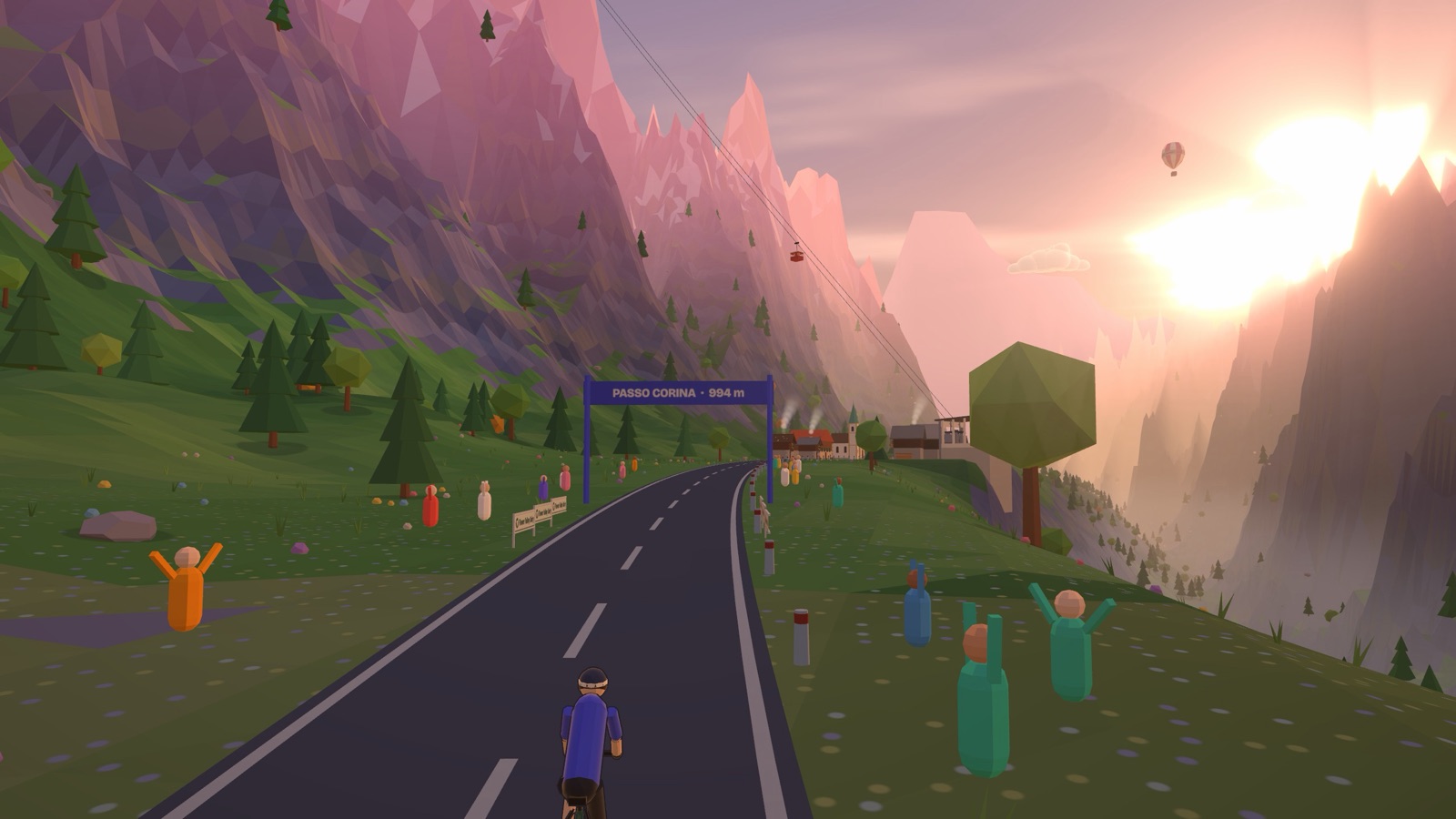A rider reaching the top of Passo Corina at sunset, with people cheering by the road