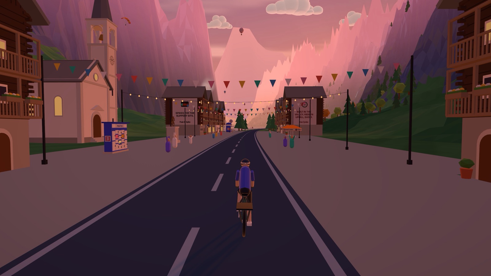 A rider cycling into an Alpine village with bunting across the street in the evening light